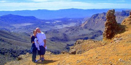 Couple posing with a scenic mountain view.